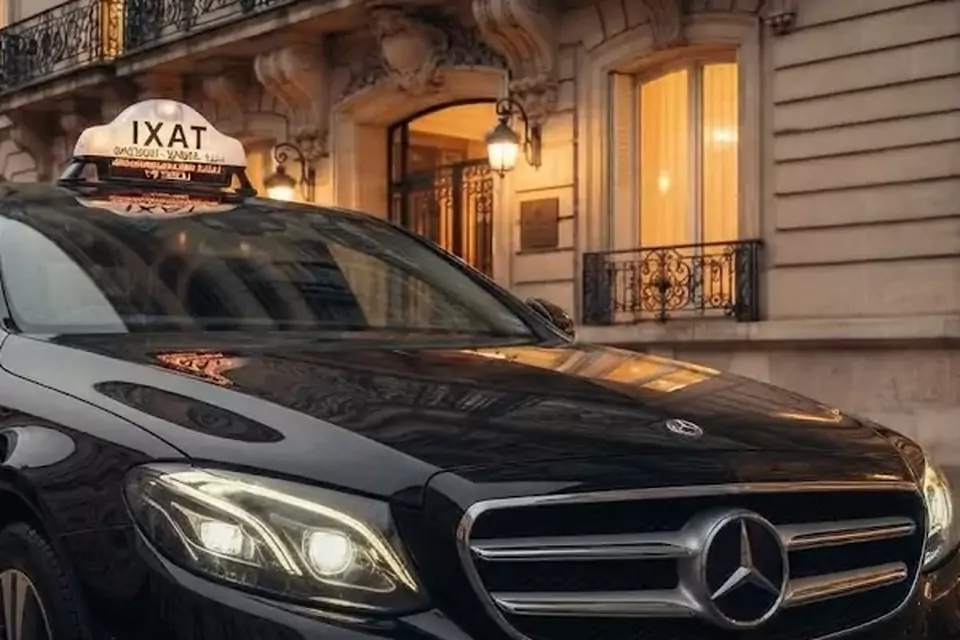 Taxi Lille Bully-les-Mines : berline noire avec enseigne taxi devant une façade éclairée