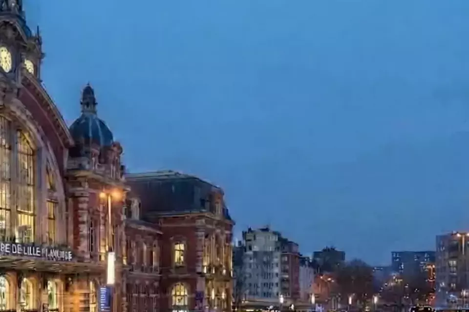 Taxi Lille Saint-Amand-les-Eaux : taxi noir stationné devant une gare en soirée
